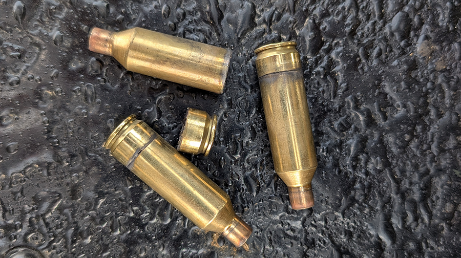 Three brass cartridge cases showing failure from case head separation